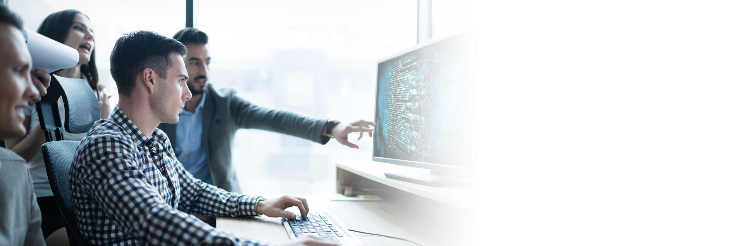 Readiness and resiliency training Hero image, people pointing at computer and discussing things.