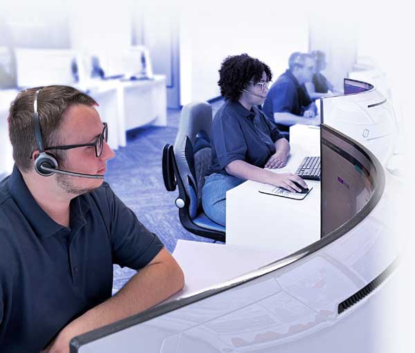 several analysts sitting at desks and working in the security operations center (SOC)