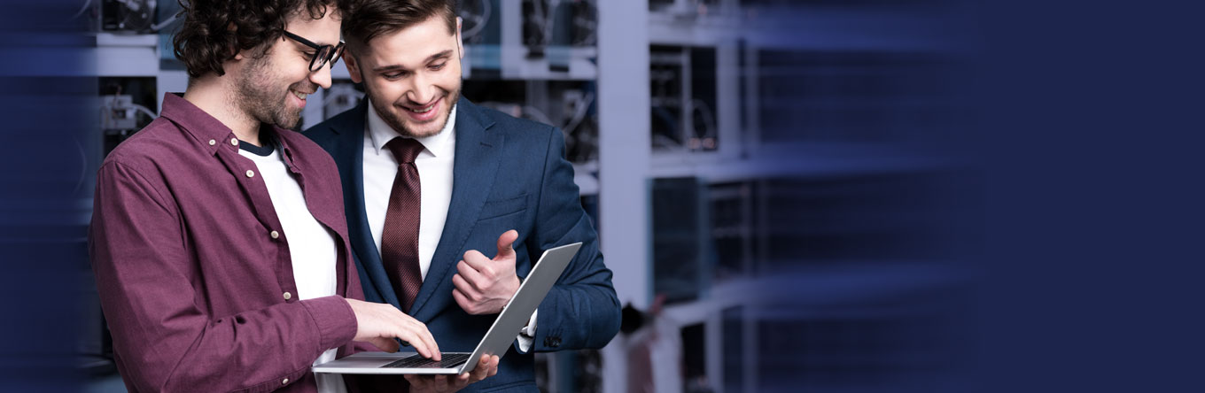 Managed Services cover image - two men looking at laptop in server room